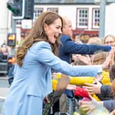 The Prince and Princess of Wales shake hands with members of the public in Carrickfergus.