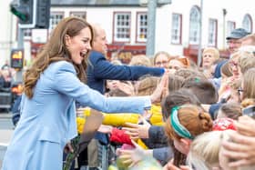 The Prince and Princess of Wales shake hands with members of the public in Carrickfergus.