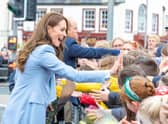 The Prince and Princess of Wales shake hands with members of the public in Carrickfergus.
