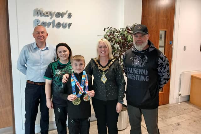 Leon Williamson pictured with Mayor of Causeway Coast and Glens, Councillor Dawn Huggins, his mum, Melanie and coach Peter McClay from Team Ryano Causeway, also included is Councillor Philip Anderson.