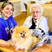 A Pets As Therapy volunteer bringing their dog to their local care home to spend time with residents