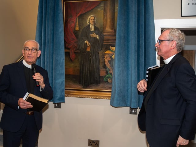Rev John Greer, left, clerk of Presbytery, unveils a portrait of Rev George Whitefield watched by Rev Alan Smylie at the official opening of Whitefield College of the Bible in Tandragee.