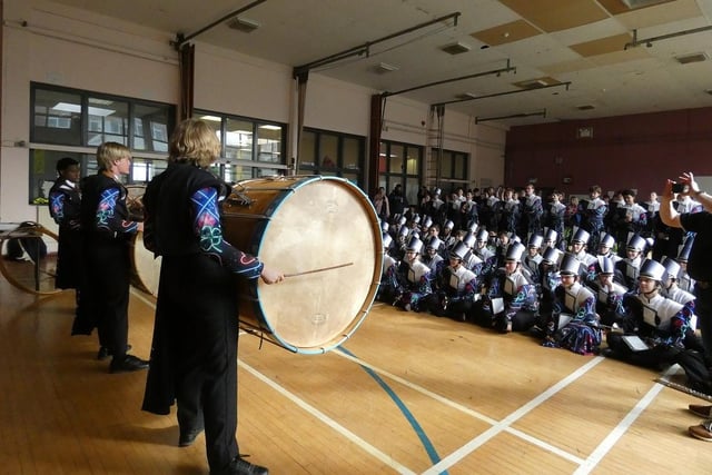 Clover percussion section members try out the lambeg drums during the workshop in Larne High School.