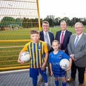 Councillor Jonathan Craig, Chair of Community and Wellbeing; Mervyn Storey, Chair of EA, Minister of Education,; Paul Givan and children from Laurelhill Community College