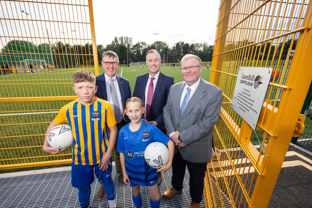 Councillor Jonathan Craig, Chair of Community and Wellbeing; Mervyn Storey, Chair of EA, Minister of Education,; Paul Givan and children from Laurelhill Community College