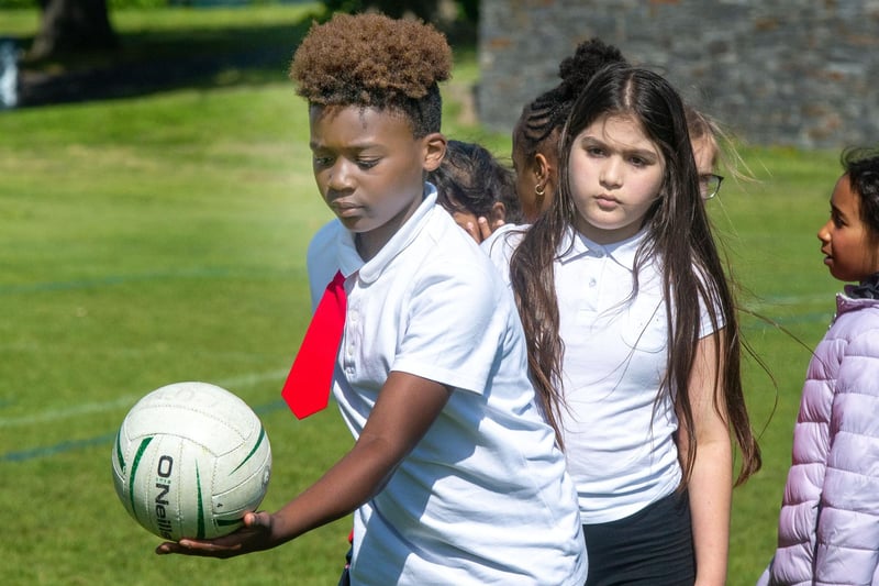 Presentation Primary School pupils learning the Gaelic football hand pass. PT23-239.
