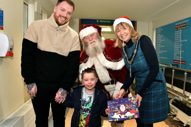 All smiles on Christmas Eve at the Blossom Unit at Craigavon Area Hospital are from left, Stuart Walker and son Freddie (4), Santa and Lord Mayor of ABC Council, Alderman Margaret Tinsley.