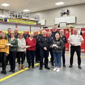Firefighters at Ballyclare Fire Station with representatives from the charities supported through the recent engine pull. (Pic: Contributed).