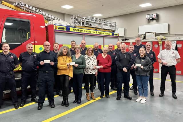 Firefighters at Ballyclare Fire Station with representatives from the charities supported through the recent engine pull. (Pic: Contributed).