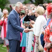 King Charles and Queen Camilla meet guests at Hillsborough Castle.