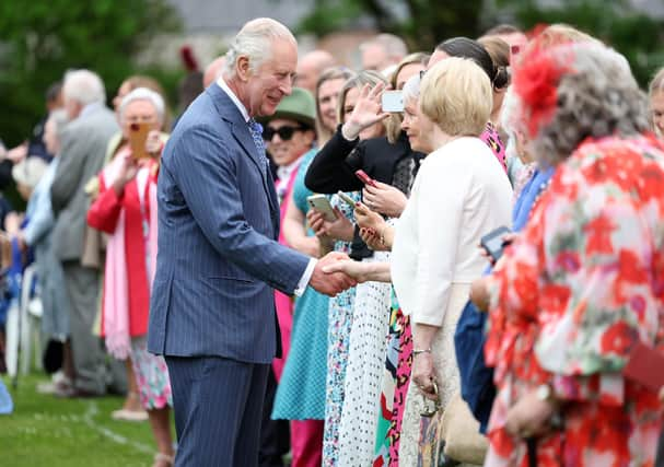 King Charles and Queen Camilla meet guests at Hillsborough Castle.