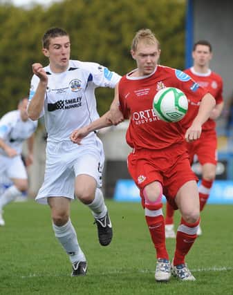 Current Portadown captain Gary Thompson playing against them for Lisburn Distillery in 2011. He's in action against Ross Redman - someone he now calls a teammate. PIC: Stephen Hamilton/Presseye