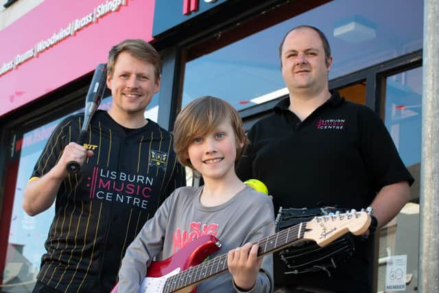 Lisburn Softball media officer Alastair Luke with Lisburn Music Centre student Elijah Luke and director James Parks.