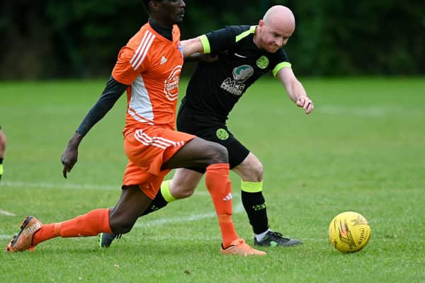 Damolly striker Ibrahim Savage shrugs of Cleary Celtic's Shay McAllister on Saturday. RS2341409
