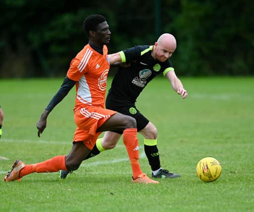 Damolly striker Ibrahim Savage shrugs of Cleary Celtic's Shay McAllister on Saturday. RS2341409
