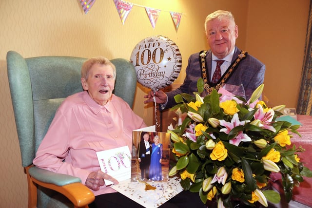 Gertrude Mullan holding her bouquet of flowers alongside the Mayor of Causeway Coast and Glens, Councillor Steven Callaghan.