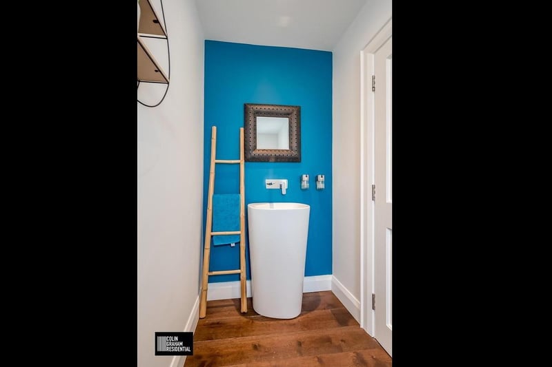 Furnished cloakroom with contemporary white two piece suite.