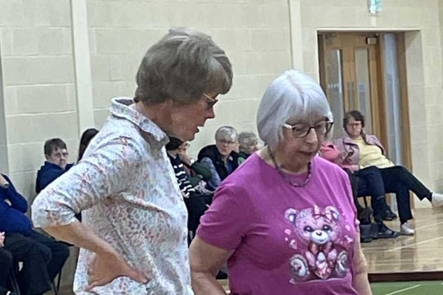 Maureen and Pearl wait for the umpire's decision.