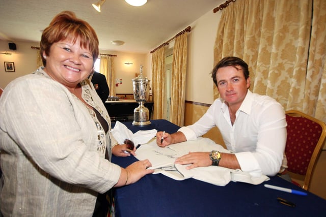 US Open Golf Champion Graeme McDowell signs a shirt for mum Marion at an autograph day at Rathmore Golf Club in 2010.
