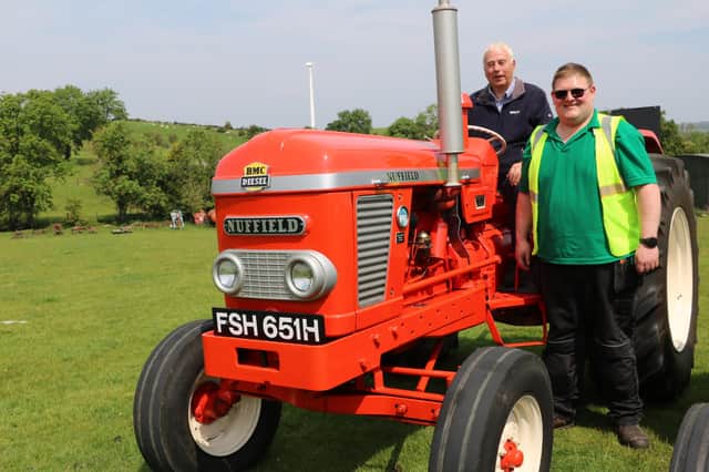 Owned by Samuel Scott from Dromore, this 1969 Nuffield 4/65 was ready for the charity  road run. Samuel is seated on the vehicle and  is pictured with Dromara Vintage and Classic Club member Stephen McCann.