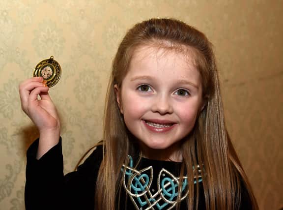 Ada Forker (6) proudly shows off her gold medal which she won in the Under 6 Reel/Jig competition at Portadown Folk Dancing Festival on Saturday. PT12-205.