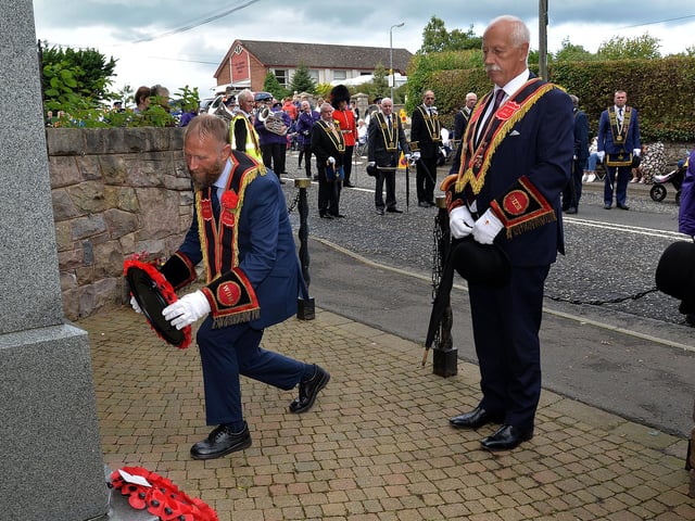 The RBP Last Saturday parade in Loughgall pauses at the War Memorial to lay a wreath. PT35-204.
