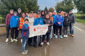 Members of Moneydig Flute Band alongside Isaac's dad Mark and brothers Adam and James setting off on their walk from Ballyronan to Garvagh.