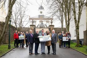 Recognising the successful multi-million Belfast Region City Deal funding bid for 'Destination Royal Hillsborough' are: (Front l-r): Councillor Uel Mackin, BRCD Council Panel member; Alderman Allan Ewart MBE, Development Committee Chairman; Mayor of Lisburn & Castlereagh City Council, Councillor Scott Carson; Laura McCorry, Head of Hillsborough Castle & Gardens and Alderman Michael Henderson MBE, BRCD Council Panel member. (back left): Councillor Caleb McCready; Carole Long, Tourism Northern Ireland; Alderman Jim Dillon MBE; Penny Scott, Honorary Treasurer of St Malachy's Parish Church and Donal Rogan, Director of Service Transformation. (back right) Claire Butler, In Klover; Alderman Owen Gawith; Dawn Mitchell, Hillsborough Development Committee Chair; Yvonne Burke, Regeneration & Infrastructure Manager and Emron Irwin, Chairperson of the Hillsborough Village Centre Committee.