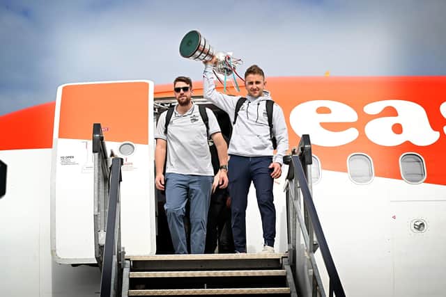 Belfast Giants' captain David Goodwin with the playoff trophy and goalie Tyler Beskorowany after the Giants arrived back in Northern Ireland. Picture: PressEye