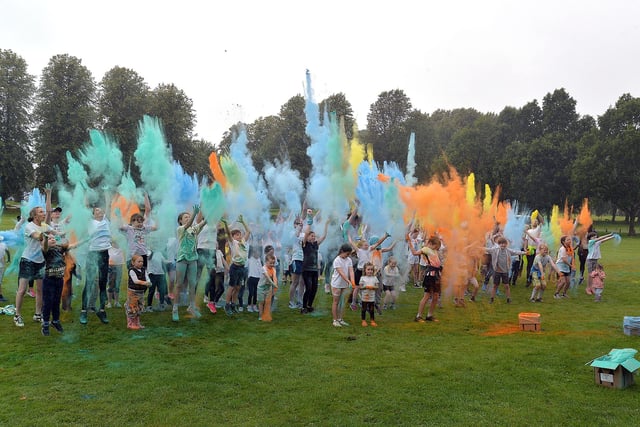Colouring up...runners in Sunday's colour run in Lurgan Park launch their coloured powders at the start of the event. LM35-220.
