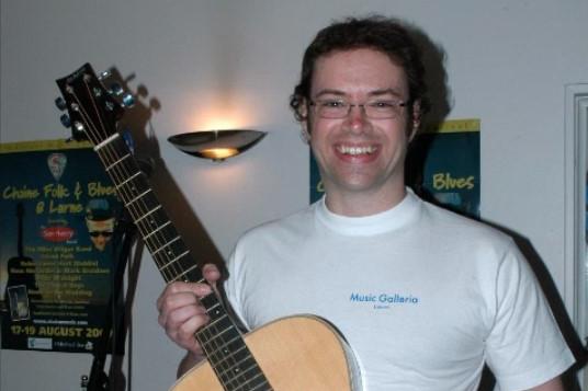 Musician Cloin Johnston of Music Galleria was donating this Ashton guitar as a prize during the 2007 Chaine Music Folk and Blues Festival in Larne
