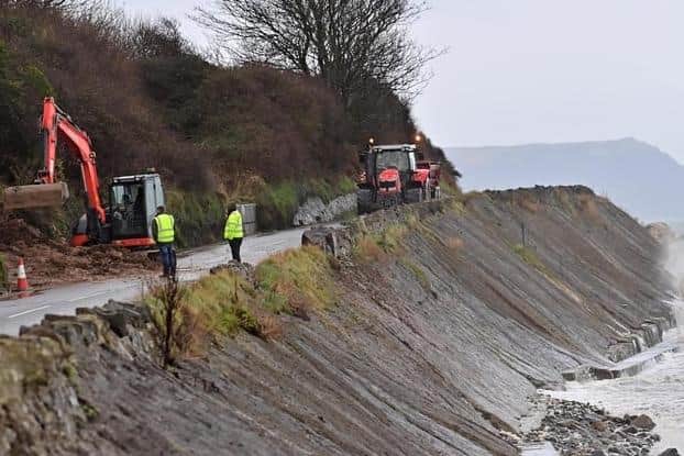 Workmen at the scene of last month's Coast Road landslide. The route has again been impacted by adverse weather conditions. Photo: Colm Lenaghan / Pacemaker