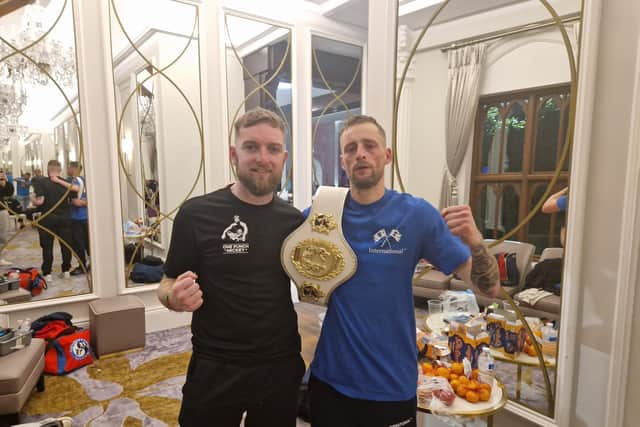 Karl Agnew (blue) with trainer Iain Mahood after his victory at the Tullyglass Hotel. (Pic: Contributed).