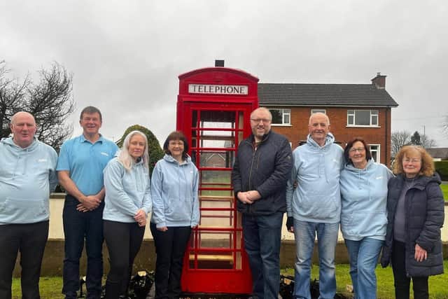Members of Annahilt and Magheraconluce Community Association with Councillor Andrew Gowan at the new telephone box library. Pic credit: Annahilt and Magheraconluce Community Association
