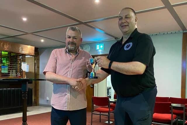 Mervyn Fleck receiving the Blue Circle Cup from Phil Cole. Photo courtesy of James Hunter