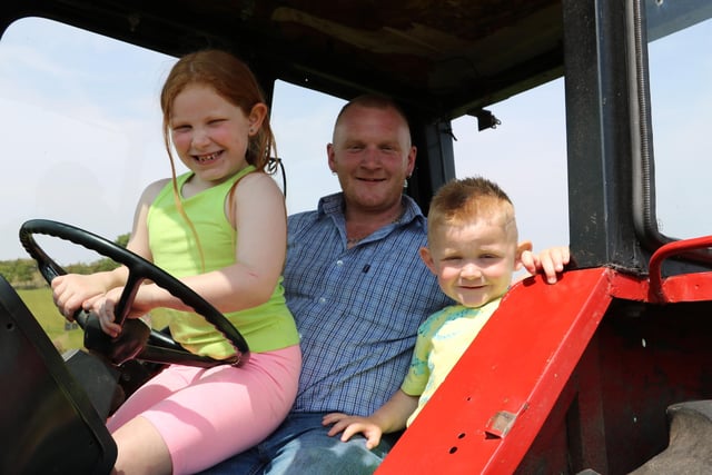 Dromara dad William McKeown Lillana (7) and William junior (4) brought their International tractor to the run.