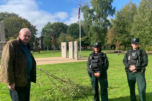 Steve Aiken MLA alongside police officers in Ballyclare War Memorial Park.