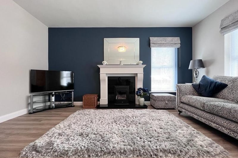 The stylish living room has a wood burning stove - just perfect for cosy nights in.