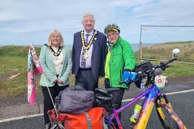 TV presenter Timmy Mallett is cycling around the UK and Ireland and has reached the Causeway Coast. Here he met with the Mayor and Deputy Mayor of Causeway Coast and Glens Borough Council, Steven Callaghan and Margaret Anne McKillop.