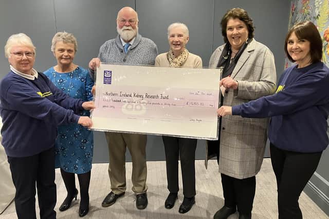 Caring Caretaker Davy Boyle and his wife Teresa (centre) present £15,925.32 to representatives of NI Kidney Research Fund (from left) Ann McCormick, Alison McCaughan, Paula McIntyre and Lenore McKeeman