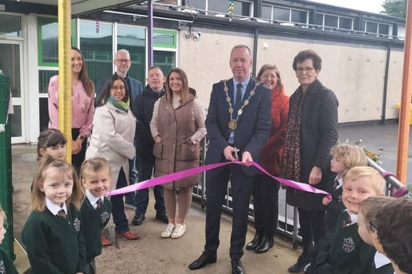 Deputy Mayor Gary McCleave along with Mrs Milne the Principal and members of the PTFA along with P1 pupils officially open the new play area at St Aloysius Primary. Pic credit: St Aloysius Primary