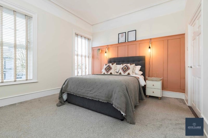 The bright master bedroom has a fabulous high ceiling with cornicing and ceiling rose.
