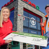 Stephen Marshall, from Eco Rangers NI, with Bronagh Luke, from Spar NI, to receive a cheque for £2,000 as part of the retailer's Community Cashback Grant Scheme.