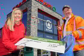 Stephen Marshall, from Eco Rangers NI, with Bronagh Luke, from Spar NI, to receive a cheque for £2,000 as part of the retailer's Community Cashback Grant Scheme.