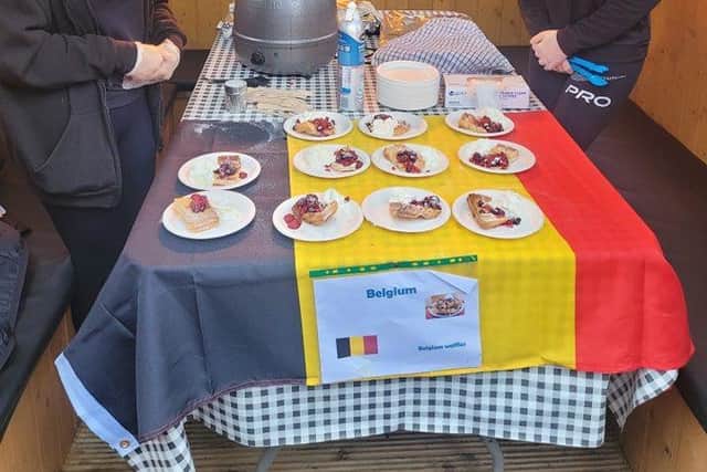 Volunteers Poppy Brown and Keeley Walker help out at the Belgian stand at the Foods of the World Festival. Pic credit: Housing Executive