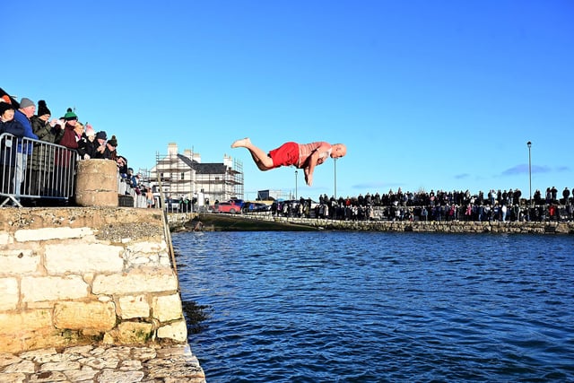 This swimmer makes a dramatic dive into the harbour in Carnlough.
