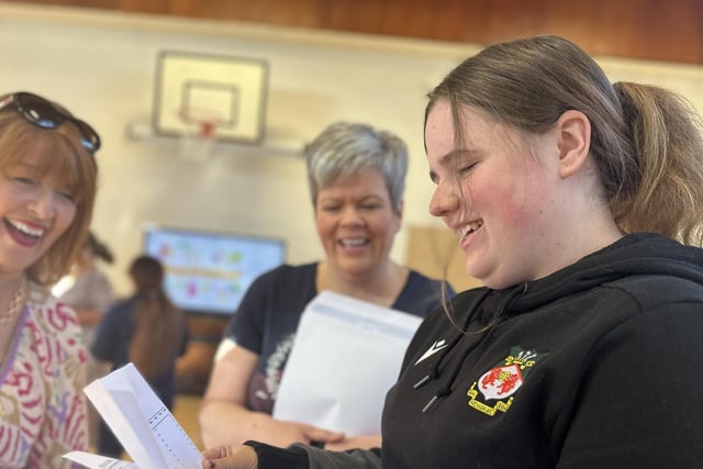 Smiles of overjoy from Kassie Blanton as she receives outstanding GCSE results at St John the Baptist's College. Looking on is her delighted mum Lindsey and Mrs Brenda Leathem.