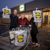 Pictured celebrating their winning dash is Lidl Portadown store manager Peter Vastag and winning customer Jennifer McShane with daughter Tanya McShane. Jennifer McShane walked away with a festive feast worth £167.55.