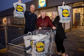 Pictured celebrating their winning dash is Lidl Portadown store manager Peter Vastag and winning customer Jennifer McShane with daughter Tanya McShane. Jennifer McShane walked away with a festive feast worth £167.55.