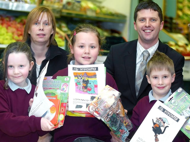 Pupils from Ballycastle Integrated PS pictured with their prizes from a 2009 Halloween Colouring Competition held by Vivoxtra, Ballycastle. Included are Store Manager Jonathan Mitchell and Assistant Manager Lynne Mitchell.BM48-200JC